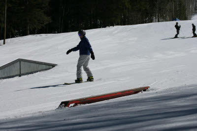 Dawn snowboarding through the terrain park