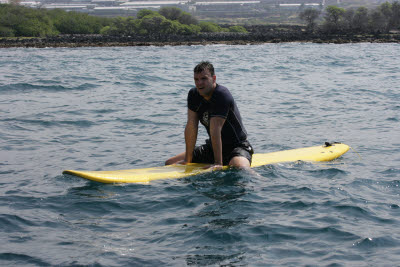 K.C. Sitting on a Surf Board