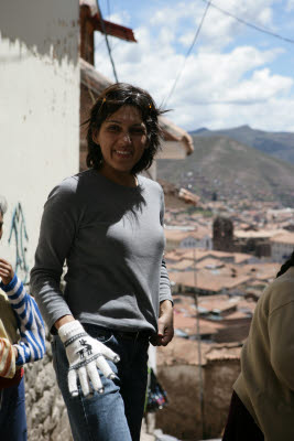 Amynah trying on some street vendor gloves in Cuzco, Peru