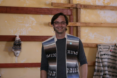 Mark tries on a vest at the Tequile market
